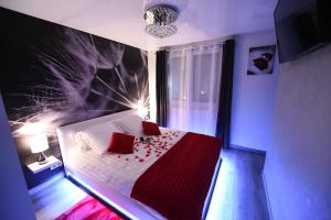 a bedroom with a bed with red pillows on it at "glamappartspa" design experience & Parking in Dijon