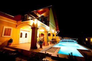 a house with a swimming pool in front of it at Villa Mikes Siófok in Siófok