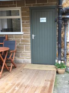 a green front door of a house with a table at @ No.4 in Castle Cary