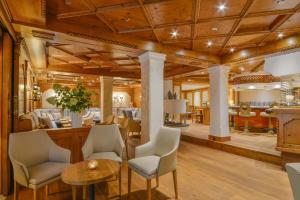 a salon with wooden ceilings and chairs and a table at Doerr Landhotel & Spa in Bad Laasphe