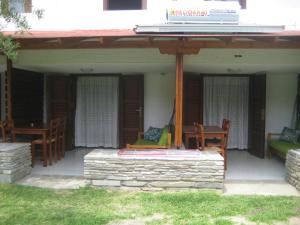 a patio with chairs and a table on a house at Petradaki Apartments in Mola Kalyva