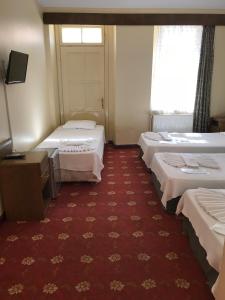 Ein Bett oder Betten in einem Zimmer der Unterkunft Antik Ridvan Hotel