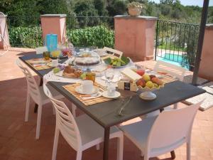 a table with food on it on a patio at La corte di Bafè B&B "Slow Life" in Zafferana Etnea