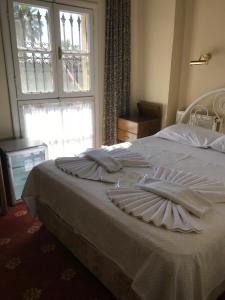 Ein Bett oder Betten in einem Zimmer der Unterkunft Antik Ridvan Hotel