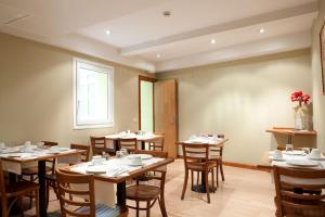a dining room with tables and chairs and a window at Ateneo Puerta del Sol in Madrid +35 photos