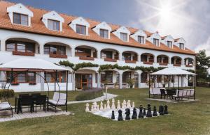 a large building with a chessboard in front of it at Hotel Mörbischerhof in Mörbisch am See