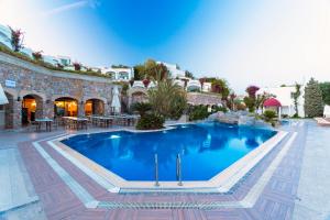 a large swimming pool with a balcony at Royal Asarlik Beach Hotel - Ultra All Inclusive in Gümbet
