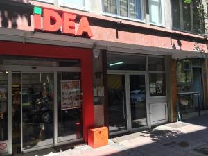a store with a red sign on the front of it at L9 Top Central Rooms and Apartments 2 in Belgrade