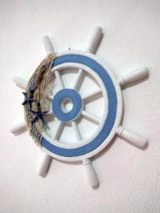 a blue and white fan on a wall at Roses RT apartments Skioni I in Nea Skioni