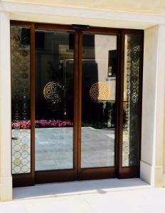 a glass door with a reflection of a building at Santa Croce Boutique Hotel in Venice