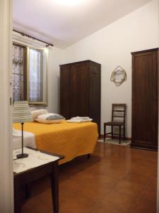 a bedroom with a bed and a table and a chair at Da Fiore in Cecina