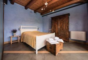 a bedroom with a large bed and a wooden cabinet at Agriturismo Gallo in Cortemilia +131 photos