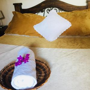 a pair of socks and a basket on a bed at La Serrana Hostal Spa in Socorro
