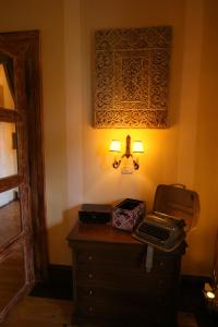 
a desk with a lamp and a lamp post at Zabola Estate - Transylvania in Zăbala
