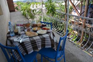 a table with a plate of food on a balcony at Friends House in Kutaisi