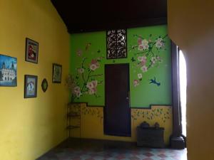 a room with a door with flowers on the wall at Casa Vieja Guest House in Santa Ana