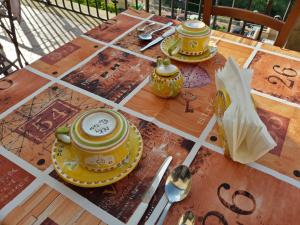 a wooden table with two cups and spoons on it at B&B Palazzo Lupo in Centola