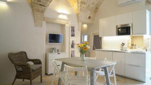 Una cocina y un comedor con mesa y sillas. en Casa Zia Anna, en Ceglie Messapica