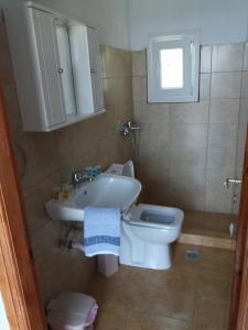 a bathroom with a sink and a toilet at Stafylos Rooms in Stafylos