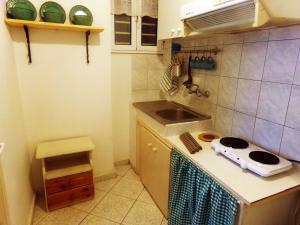 a small kitchen with a stove and a sink at Leia Guest House in Ermoupoli