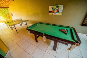 a pool table in a room with a table at Pousada Do Capitão in Florianópolis +97 photos