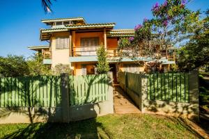 a house with a gate and a fence at Pousada Do Capitão in Florianópolis