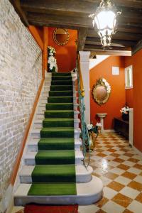 a stairway with green and white stairs in a room at B&B Beroni a Venezia in Venice