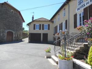 a building with a staircase in front of a house at Maison de Vacances Le Ranfort in Sousceyrac