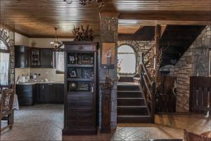 a kitchen with a staircase and a stair case at Stone Mansion Anavryti, ΑΜΑ 20569 in Mystras