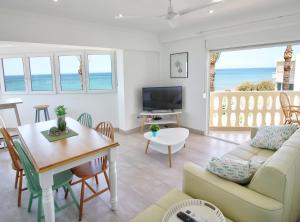 a living room with a couch and a table at Apartamentos Oliver Playa in Denia