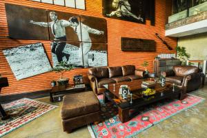 a living room with couches and a wall with a mural at Alfonsina Hotel Boutique in Santa Cruz de la Sierra