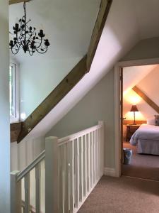 a attic bedroom with a bed and a chandelier at The Foretop in Cardiff