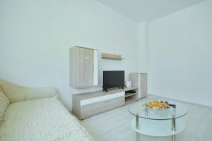 a living room with a couch and a table with a tv at Apartment Mirela in Zadar