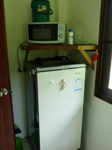 a microwave sitting on top of a refrigerator at Seagull Villa in Ko Lanta