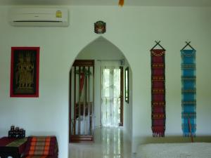 a white room with a bed and a window at Seagull Villa in Ko Lanta