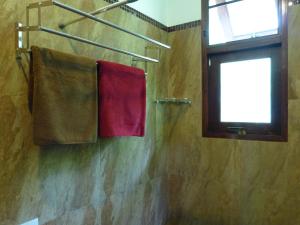 a bathroom with two towels hanging on a wall at Seagull Villa in Ko Lanta