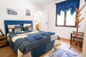 a bedroom with a bed with a blue and white comforter at Lyon Mon Amour B&B in Lyon