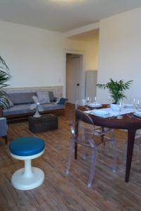 a living room with a table and chairs and a couch at 1861 Liston Boutique flat in Corfu Town