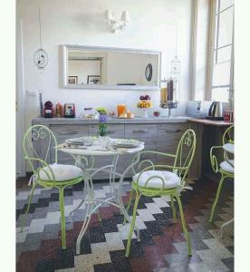 a kitchen with a table and chairs in a kitchen at Aretè Guest House in Siracusa