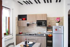 a kitchen with a white refrigerator and a table at Jazz & Blues Apartments near " Sentiero degli Dei " in Agerola