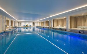 a swimming pool in a hotel with two beds at Eastwell Manor, Champneys Hotel & Spa in Ashford