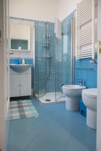 a bathroom with a sink and a toilet and a shower at Aurora Sul Mare in Otranto