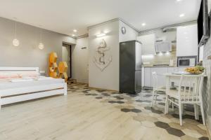 a living room with a bed and a kitchen at VIP apartment Blue Whale in Odesa