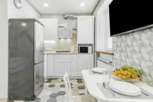 Una cocina con una mesa con un bol de fruta encima. en VIP apartment Blue Whale, en Odessa 6 fotos más