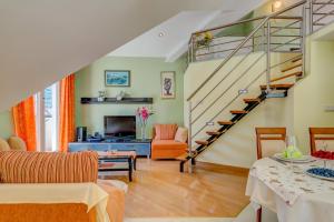a living room with a staircase and a living room at Natali in Omiš