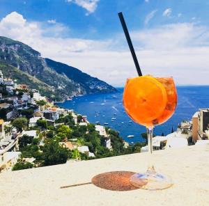 a drink sitting on a ledge with a view of the ocean at Hotel Posa Posa in Positano