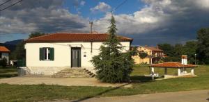 ein kleines weißes Haus mit einem Baum davor in der Unterkunft Villa Zwei Zedern in Pićan
