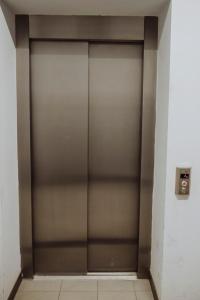 ニサにあるŚpij w Nysie Apartmentsの建物内金属製エレベータードア