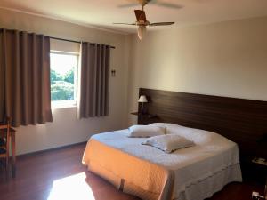 A bed or beds in a room at Hotel Carajás