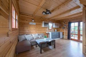 a living room with a couch and a table at Domek w sercu Kaszub in Sominy